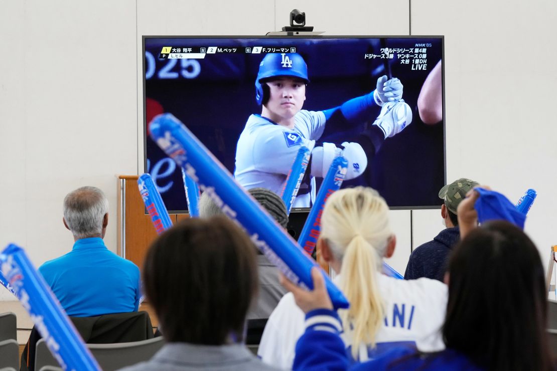 People watch Shohei Ohtani of the Los Angeles Dodgers during Game 4 of the baseball World Series between the Dodgers and the New York Yankees during a public viewing event in Ohtani's hometown of Oshu, northeastern Japan, on October 30, 2024.