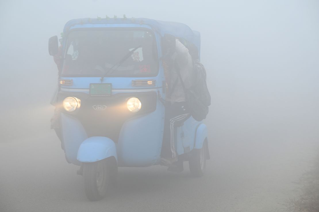 Commuters step out in a foggy winter morning amid rising air pollution, on November 19, 2024 in Greater Noida, India.